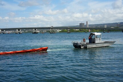 Joint Task Force-Red Hill (JTF-RH) and spill response personnel deploy a water barrier during a spill response exercise at Joint Base Pearl Harbor-Hickam, Hawaii, July 13, 2023.