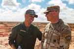 Master Sgt. Aghzaf Abdelkrim from the 15th Regiment Royal Char and Master Sgt. Joe Carson, from the  3-116th Combined Arms Battalion, 116th Cavalry Brigade Combat Team, chat while their soldiers boresight their tanks before gunnery during African Lion at Tan Tan, Morocco June 7, 2023.