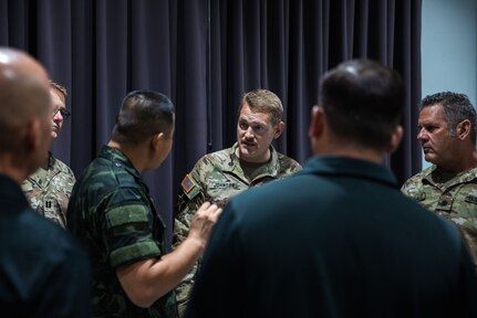 Maj. Joel Johnson, Bilateral Affairs Officer in the Kingdom of Thailand talks with one of his Royal Thai Army counterparts during a State Partnership Program Exchange on July 31, 2022.