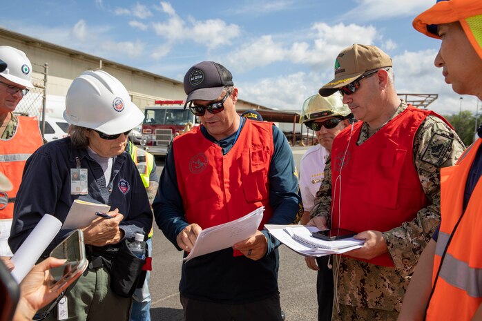 Joint Task Force-Red Hill (JTF-RH) personnel and stakeholder representatives review documents during a spill response exercise on Joint Base Pearl Harbor-Hickam, Hawaii, July 13, 2023.