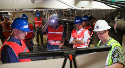 Defense Logistics Agency liaison to Joint Task Force-Red Hill (JTF-RH), U.S. Navy Cmdr. Bill Jakubowicz (far right), briefs Edward Meier, Associate Director for National Security Programs, U.S. Office of Management and Budget, (center right) during a tour of the Red Hill Bulk Fuel Storage Facility (RHBFSF), Halawa, Hawaii, July 12, 2023.