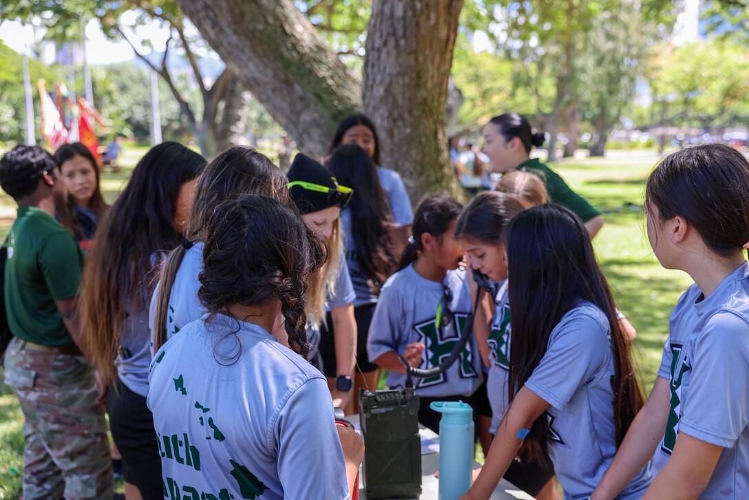 Youth Impact program participants participate in communications lanes during Army Day, Fort DeRussy Military Reservation, Hawaii, July 14, 2023. The Hawaii Youth Impact Program brings together service members, University of Hawaii faculty and local volunteers to cultivate leadership, discipline and mentorship skills among aspiring youth.