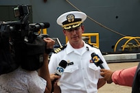 NORFOLK, Va. - Cmdr. Robert D. Ireland, commanding officer of the Arleigh Burke-class guided-missile destroyer USS James E. Williams (DDG 95), speaks with local media outlets following the ship's return to Naval Station Norfolk after a seven-month NATO deployment, July 14, 2023. James E. Williams served as the flagship for Standing NATO Maritime Group (SNMG) 2. (U.S. Navy photo by Mass Communication Specialist 1st Class Jacob T. Waldrop)