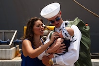 NORFOLK, Va. - Electronics Technician 3rd Class Nicholas Engstrom meets his child from the first time following Arleigh Burke-class guided-missile destroyer USS James E. Williams' (DDG 95) return to Naval Station Norfolk after a seven-month NATO deployment, July 14, 2023. James E. Williams served as the flagship for Standing NATO Maritime Group (SNMG) 2. (U.S. Navy photo by Mass Communication Specialist 1st Class Jacob T. Waldrop)