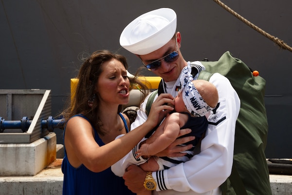 NORFOLK, Va. - Electronics Technician 3rd Class Nicholas Engstrom meets his child from the first time following Arleigh Burke-class guided-missile destroyer USS James E. Williams' (DDG 95) return to Naval Station Norfolk after a seven-month NATO deployment, July 14, 2023. James E. Williams served as the flagship for Standing NATO Maritime Group (SNMG) 2. (U.S. Navy photo by Mass Communication Specialist 1st Class Jacob T. Waldrop)