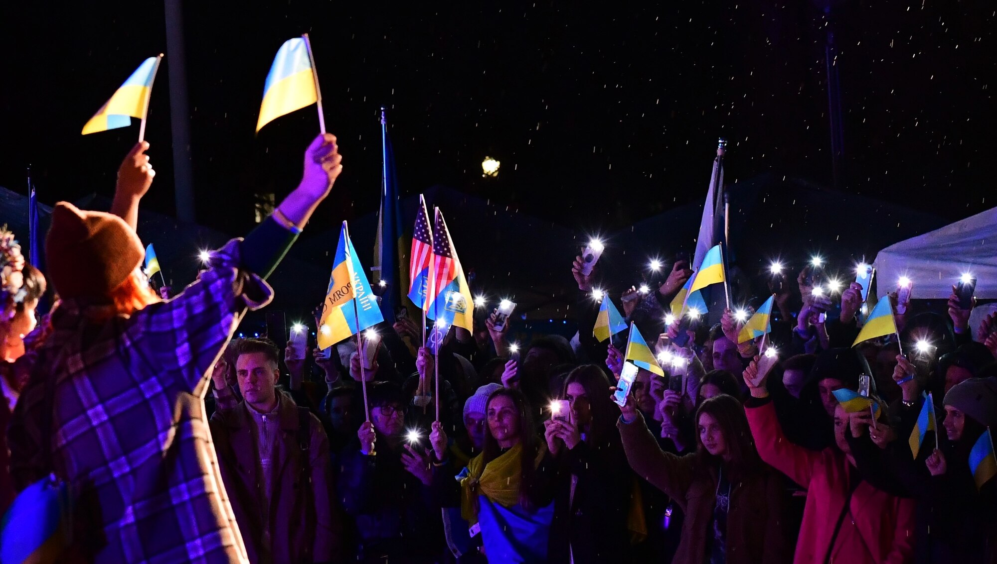 Attendees stand in front of the audience during a 'flash mob' to show their support at the 365-days of Ukrainian Bravery rally in Sacramento, California, Feb. 24, 2023.