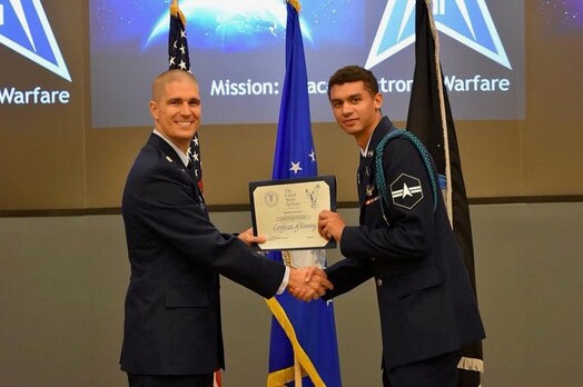  U.S. Space Force Spc. 3 Kevin Capone poses for an official photo after receiving a training certificate. Capone serves as an Electromagnetic Warfare Operator with the 5th Electromagnetic Warfare Squadron.