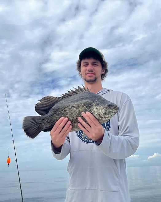  U.S. Space Force Spc. 3 Kevin Capone poses with a fish. In his free time, Capone also enjoys video games, sports and collecting vintage baseball cards.