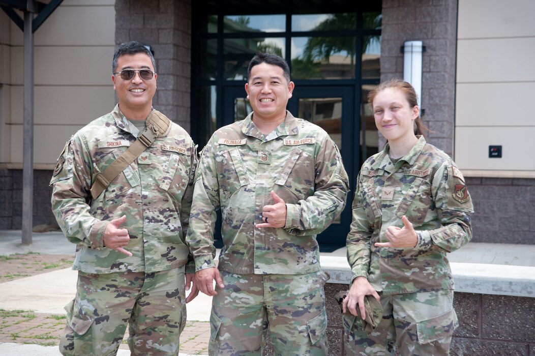Staff Sgt. Robert Shikina, Master Sgt. Neil Fujinaga, and Senior Airman Katarina Kossen, 154th Communications Squadron communication specialists, gather at their unit July 12, 2023, at Joint Base Pearl Harbor-Hickam, Hawaii.