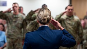 Lt. Col. Wendy Cook, 49th Health Care Operations Squadron outgoing commander, receives a final salute from 49th HCOS members