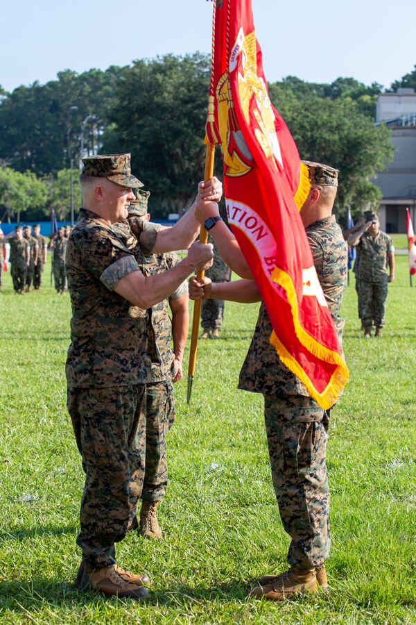 U.S. Marine Corps Col. Karl Arbogast, outgoing commanding officer, Marine Corps Air Station (MCAS) Beaufort, passes the colors to Col. Mark Bortnem, incoming commanding officer, MCAS Beaufort, during a Change of Command Ceremony at MCAS Beaufort, South Carolina, July 7, 2023. The passing of the colors signifies the continuation of trust and allegiance of the Marines to their squadron’s commander. (U.S. Marine Corps photo by Lance Cpl. Nathan Saucier)