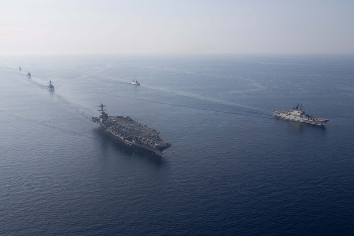 The Gerald R. Ford Carrier Strike Group sails in formation with NATO allied ships during an integrated sailing event, July 11, 2023. The ships sailing include the world’s largest aircraft carrier USS Gerald R. Ford (CVN 78), French Navy frigate FS Languedoc (D653), Arleigh Burke-class guided-missile destroyer USS Ramage (DDG 61), Ticonderoga-class guided-missile cruiser USS Normandy (CG 60), Arleigh Burke-class guided missile destroyer USS Thomas Hudner (DDG 116) and Italian guided-missile frigate ITS Carabiniere (F593). Gerald R. Ford is participating in Neptune Strike, a multiyear effort focused on harmonizing U.S. and NATO planning teams to transfer command and control of Allied naval and amphibious forces to STRIKFORNATO, in order to provide assurance, deterrence, and collective defense for the Alliance. (U.S. Navy photo by Mass Communication Specialist 2nd Class Jacob Mattingly)