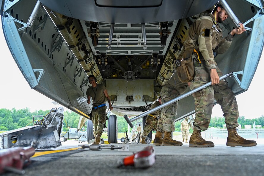 Airman 1st Class Timothy McDonald and Airman 1st Class Jordan Scotland, aircraft armaments system technicians from the 69th Bomb Squadron, prepare the bomb bay of a B-52H Stratofortress for unloading at Joint Base Elmendorf-Richardson, Alaska, July 11, 2023. Assets from the B-52 will be utilized during training missions with the other supporting units in JBER’s joint training environment. (U.S. Air Force photo by Senior Airman Zachary Wright)