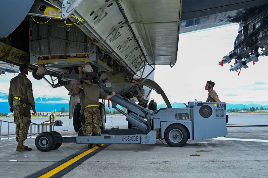 Maintenance Airmen from the 69th Bomb Squadron at Minot Air Force Base, North Dakota, unload a B-52H Stratofortress in support of a bomber Agile Combat Employment exercise at Joint Base Elmendorf-Richardson, Alaska, July 11, 2023. ACE enables convergence across domains, presenting an adversary with dilemmas at an operational tempo that complicates or negates adversary responses. (U.S. Air Force photo by Senior Airman Zachary Wright)