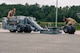 Airman 1st Class Timothy McDonald and Airman 1st Class Jordan Scotland, 69th Bomb Squadron aircraft armament systems technicians, prepare their equipment to unload a B-52H Stratofortress at Joint Base Elmendorf-Richardson, Alaska, July 11, 2023. The Airmen were sent to JBER to maintain the B-52s during a bomber Agile Combat Employment exercise in conjunction with the B-1B Lancer and B-2 Spirit. (U.S. Air Force photo by Senior Airman Evan Lichtenhan)