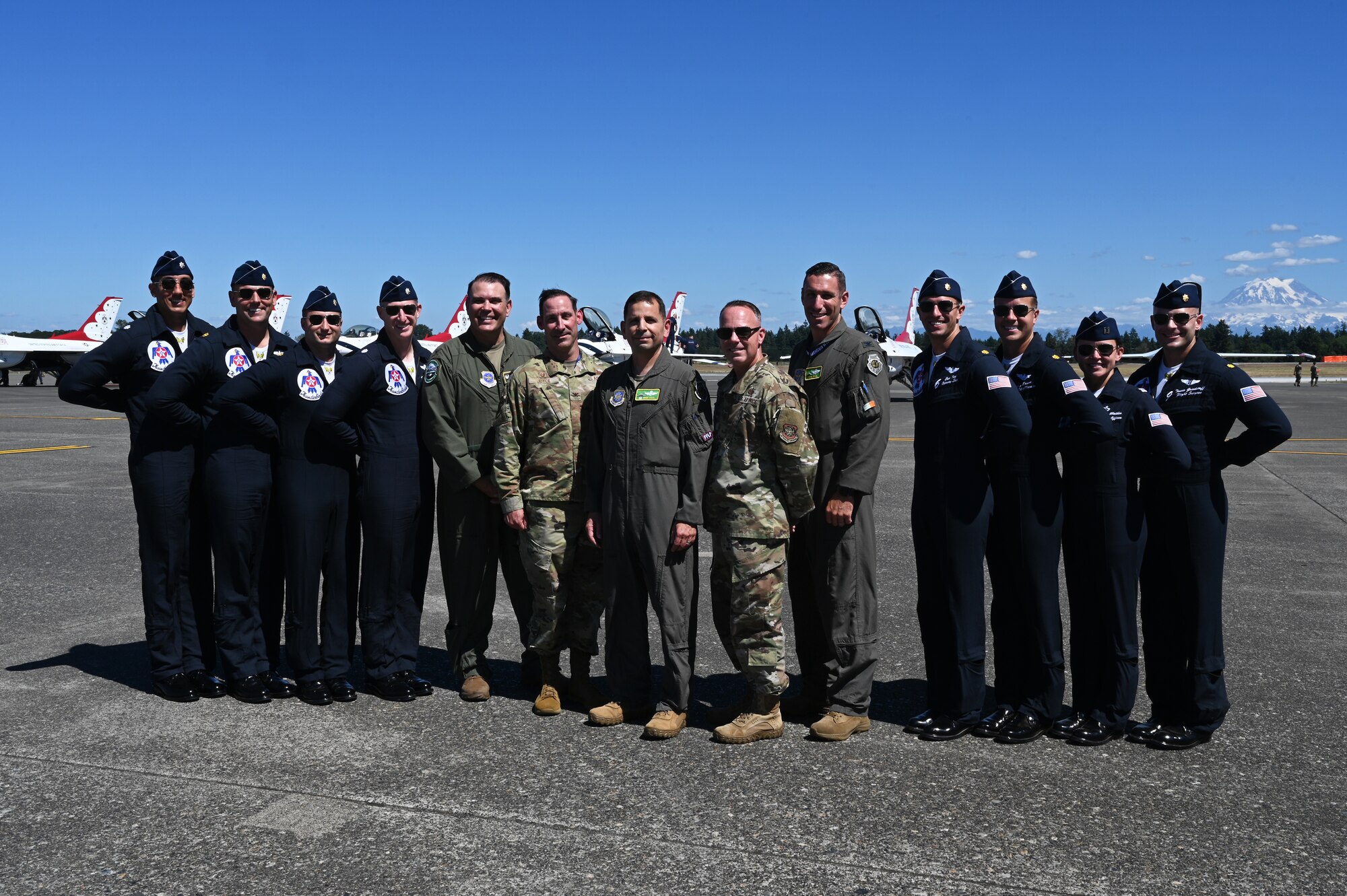 62d Airlift Wing leadership pose for a photo with the U.S. Air Force Air Demonstration Squadron “Thunderbirds” upon arrival for the Joint Base Lewis-McChord Airshow and Warrior Expo at JBLM, Washington, July 13, 2023. The mission of the JAWE is to foster goodwill to educate and familiarize attendees with the people, mission, and equipment of the Air Force, Army, and other Armed Services while continuing to provide installation-wide mission support. The Thunderbirds are one of the JAWE’s premier acts and will be joined by aerial demonstrations from the C-17 West Coast Demonstration Team, Tora! Tora! Tora! and many more. (U.S. Air Force photo by Senior Airman Colleen Anthony)