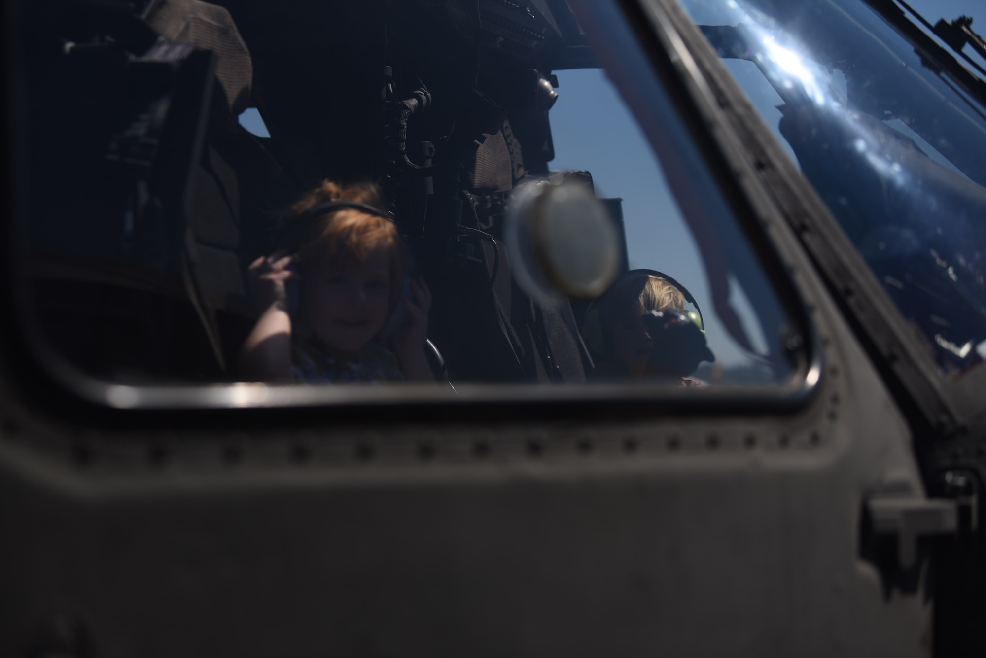 A child sits in a HH70L Blackhawk assigned to the Army National Guard Medical Evacuation Platform during the Meet Your Military event before the Joint Base Lewis-McChord Airshow and Warrior Expo at JBLM, Washington, July 14, 2023. The mission of the JAWE is to foster goodwill to educate and familiarize attendees with the people, mission, and equipment of the Air Force, Army, and other Armed Services while continuing to provide installation-wide mission support. (U.S. Air Force photo by Airman 1st Class Kylee Tyus)