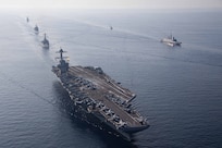 The Gerald R. Ford Carrier Strike Group sails in formation with NATO allied ships during an integrated sailing event, July 11, 2023. The ships sailing include the world’s largest aircraft carrier USS Gerald R. Ford (CVN 78), French Navy frigate FS Languedoc (D653), Arleigh Burke-class guided-missile destroyer USS Ramage (DDG 61), Ticonderoga-class guided-missile cruiser USS Normandy (CG 60), Arleigh Burke-class guided missile destroyer USS Thomas Hudner (DDG 116) and Italian guided-missile frigate ITS Carabiniere (F593). Gerald R. Ford is participating in Neptune Strike, a multiyear effort focused on harmonizing U.S. and NATO planning teams to transfer command and control of Allied naval and amphibious forces to STRIKFORNATO, in order to provide assurance, deterrence, and collective defense for the Alliance. (U.S. Navy photo by Mass Communication Specialist 2nd Class Jacob Mattingly)