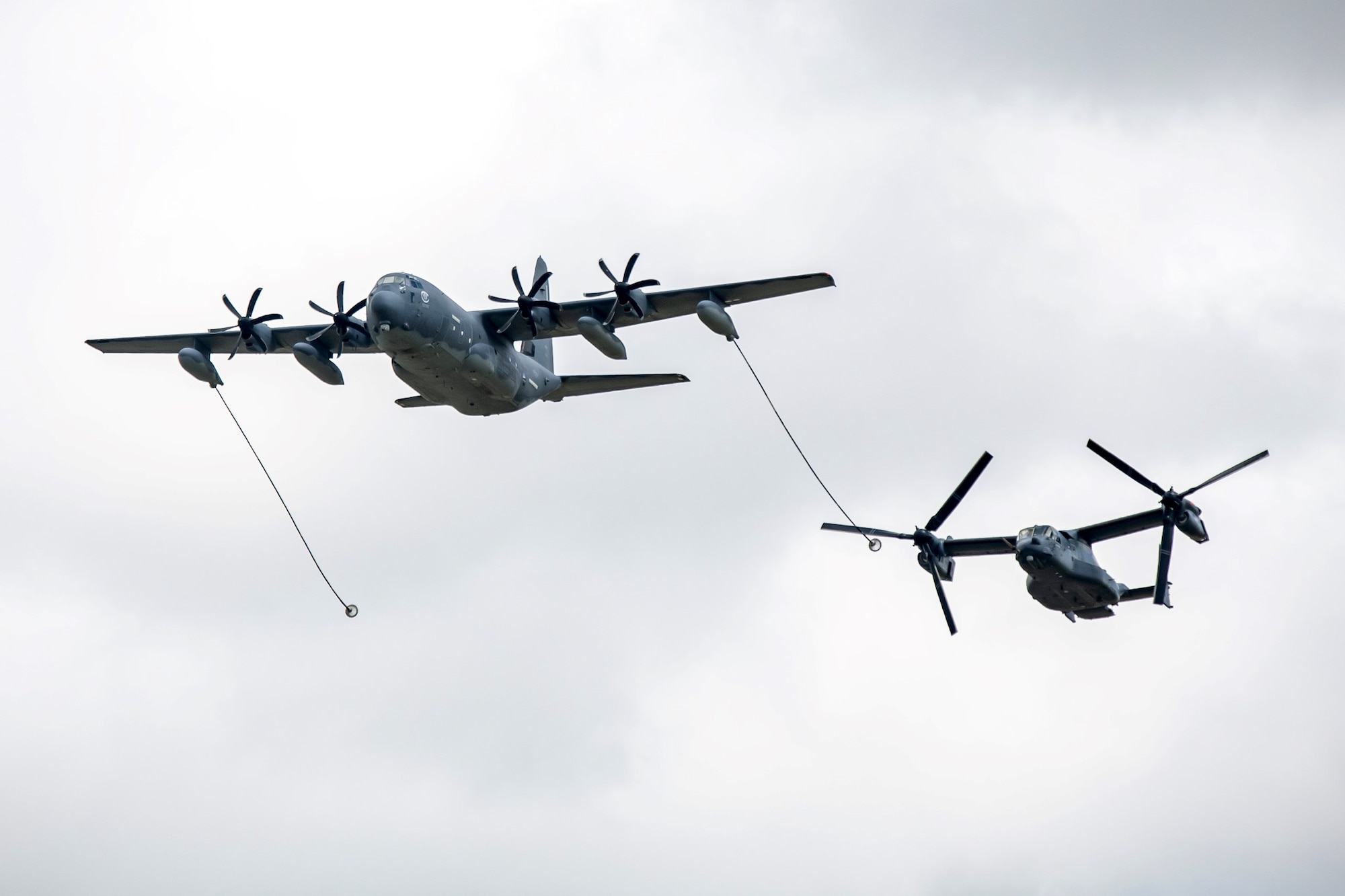 A CV-22B Osprey and MC-130J Commando II from RAF Mildenhall conducted an aerial refueling demonstration at the Royal International Air Tattoo, at RAF Fairford, England, July 15, 2023. RIAT participation demonstrates U.S. commitment to European allies and partners while highlighting U.S. capabilities to a diverse audience, emphasizing unity, innovation, and a shared commitment to excellence. (U.S. Air Force photo by Staff Sgt. Eugene Oliver)