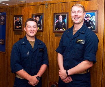 230715-N-JC445-1010 MEDITTERREAN SEA (July 15, 2023) Ensign Matthew Hedish and Ensign Michael Johnson pose for a photo in the ceremonial quarterdeck aboard the Blue Ridge-class command and control ship USS Mount Whitney (LCC 20). Mount Whitney is the U.S. 6th Fleet flagship, homeported in Gaeta, and operates with a combined crew of U.S. Sailors and Military Sealift Command civil service mariners. (U.S. Navy photo by Mass Communication Specialist 2nd Class Mario Coto)