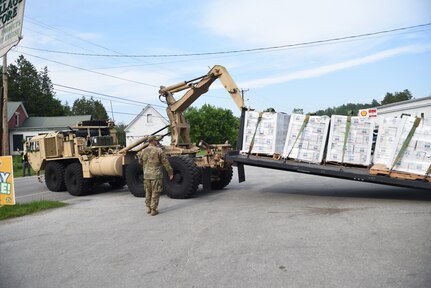 U.S. Army Staff Sgt. John Hackley, truck driver, Alpha Company, 186th Brigade Support Battalion, 86th Infantry Brigade Combat Team (Mountain), Vermont Army National Guard, guides a HEMTT-LHS delivering water, Marshfield, Vt., July 13, 2023.