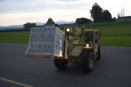 U.S. Army Sgt. Robert Maxfield, petroleum specialist, Alpha Company, 186th Brigade Support Battalion, 86th Infantry Brigade Combat Team (Mountain), Vermont Army National Guard, operates a forklift to load water onto a HEMTT-LHS, Berlin, July 13, 2023.