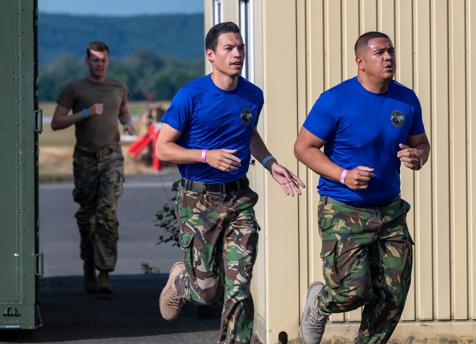 Members of the Royal Netherlands Air Force run alongside a member of the U.S. Air Force during the 521st Air Mobility Operations Wing’s Mobility Rodeo at Ramstein Air Base, Germany, July 11, 2023.
