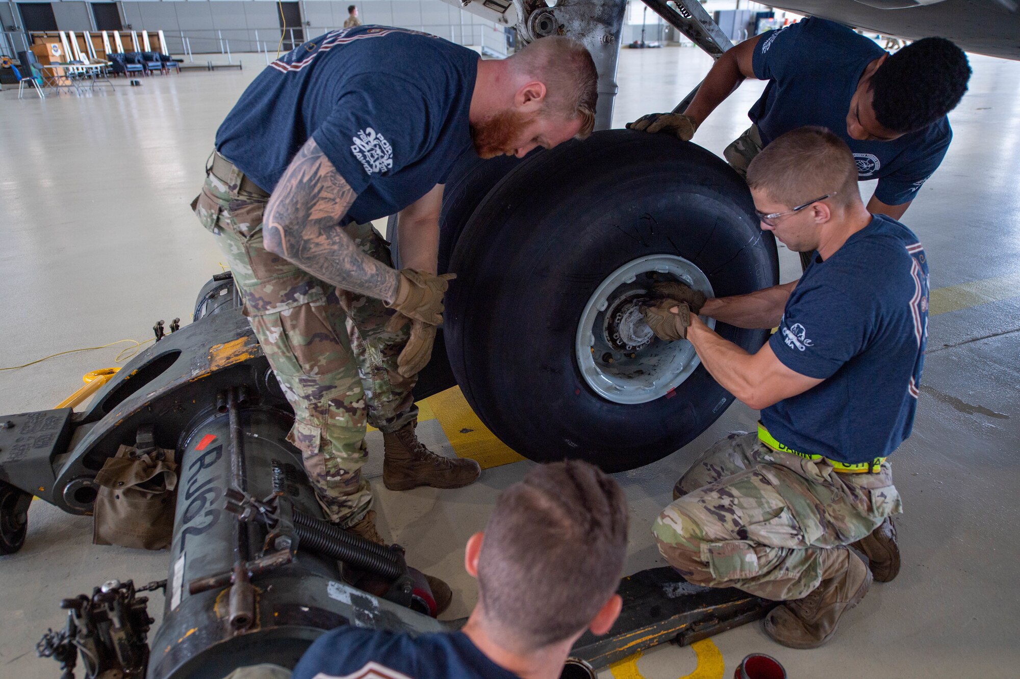 U.S. Air Force Airmen assigned to the 728th Air Mobility Squadron, Incirlik Air Base, Türkiye, remove bolts from a tire on a C-17 Globemaster III aircraft during the 521st Air Mobility Operations Wing’s Mobility Rodeo at Ramstein Air Base, July 12, 2023.