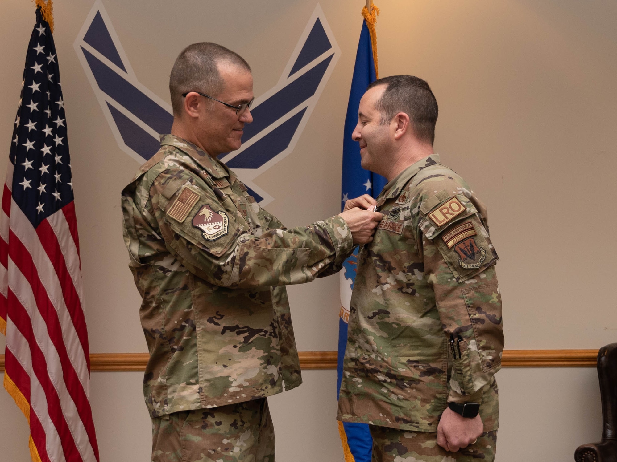 Col. Todd Walker, 4th Mission Support Group commanders, awards Lt. Col. Robert Fekete with the meritorious service medal during a change of command ceremony at Seymour Johnson Air Force Base, July 14, 2023. The ceremony was conducted to commemorate the passing of command of the 4th Logistics Readiness Squadron from Fekete to Maj. Lovell C.K. Davis Jr. (U.S. Air Force photo by Staff Sgt. Koby I. Saunders)