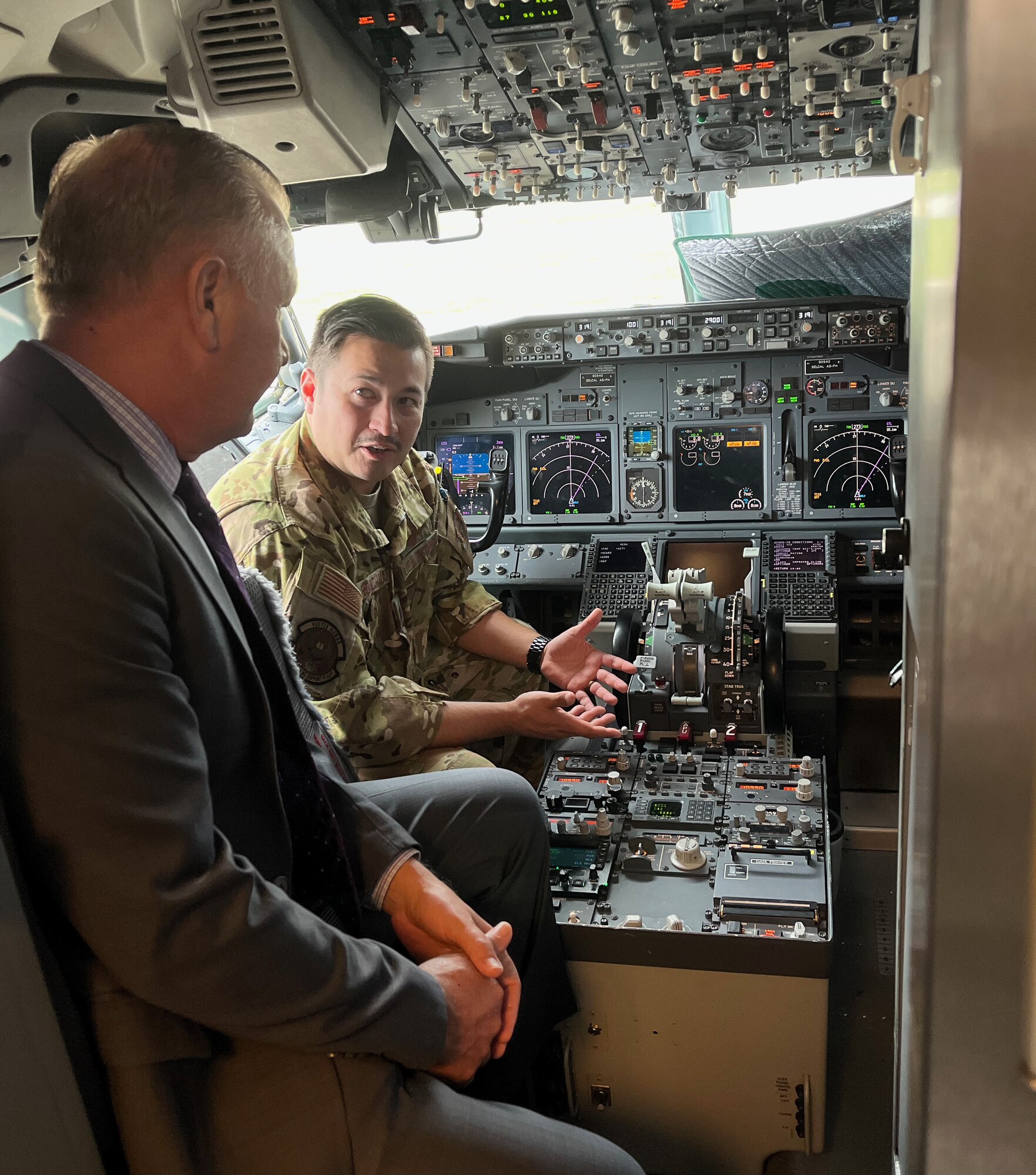 Lt. Col. Dick Robichaud, 932nd Operations Support Flight director of operations, briefs Brett Clark, AFRC Transformation and Innovation Office director of analysis, continuous improvement and innovation (CI2), in the cockpit of a C40C Clipper aircraft, June 28, 2023, Scott Air Force Base, Ill. (U.S. Air Force Photo by Maj. Neil Samson)