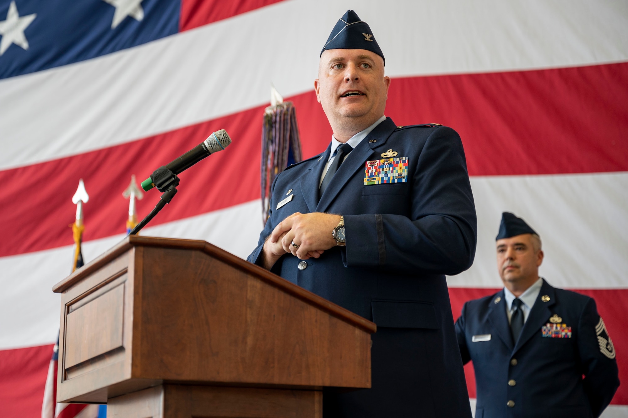 A man in uniform gives a speech during a ceremony