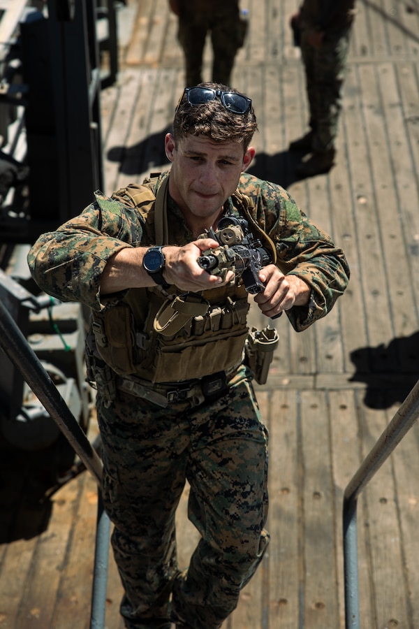 A U.S. reconnaissance Marine with 4th Reconnaissance Battalion, 4th Marine Division, walks up the stairs of a partner nation naval vessel during visit board search and seizure training for UNITAS LXIV at Cartagena, Colombia, July 13, 2023. During UNITAS, reconnaissance and special operation force Marines from 11 partnered and allied nations conducted multilateral special operations training consisting of room clearing, VBSS, jungle patrolling, low level static line jumping, small arms, and helicopter rope suspension tactics. UNITAS, which is taking place in Colombia this year, is the world’s longest-running annual multinational maritime exercise that focuses on enhancing interoperability among multiple nations and joint forces during littoral and amphibious operations in order to build on existing regional partnerships and create new enduring relationships that promote peace, stability, and prosperity in the U.S. Southern Command’s area of responsibility. (U.S. Marine Corps photo by Sgt. Colton K. Garrett)