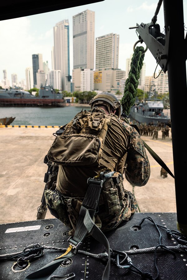 A U.S. reconnaissance Marine with 4th Reconnaissance Battalion, 4th Marine Division, sits on the edge of a U.S. Marine Corps UH-1Y Venom during helicopter rope suspension tactics training for UNITAS LXIV at Cartagena, Colombia, July 13, 2023. During UNITAS, reconnaissance and special operation force Marines from 11 partnered and allied nations conducted multilateral special operations training consisting of HRST, room clearing, visit board search and seizure, jungle patrolling, low level static line jumping, and small arms tactics. UNITAS, which is taking place in Colombia this year, is the world’s longest-running annual multinational maritime exercise that focuses on enhancing interoperability among multiple nations and joint forces during littoral and amphibious operations in order to build on existing regional partnerships and create new enduring relationships that promote peace, stability, and prosperity in the U.S. Southern Command’s area of responsibility. (U.S. Marine Corps photo by Sgt. Colton K. Garrett)