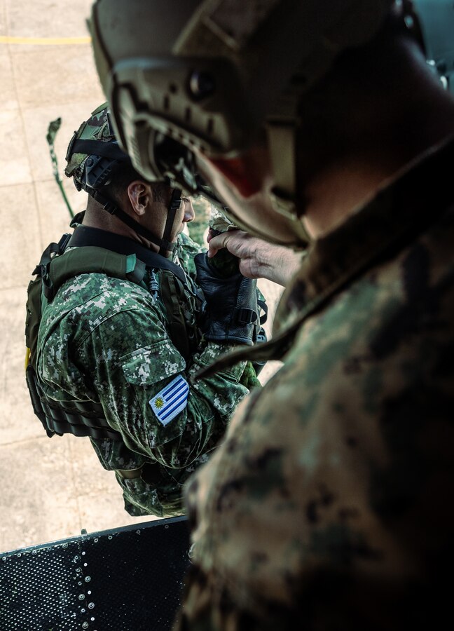 An Uruguayan Marine fast ropes from a U.S. Marine Corps UH-1Y Venom during helicopter rope suspension tactics training for UNITAS LXIV at Cartagena, Colombia, July 13, 2023. During UNITAS, reconnaissance and special operation force Marines from 11 partnered and allied nations conducted multilateral special operations training consisting of HRST, room clearing, visit board search and seizure, jungle patrolling, low level static line jumping, and small arms tactics. UNITAS, which is taking place in Colombia this year, is the world’s longest-running annual multinational maritime exercise that focuses on enhancing interoperability among multiple nations and joint forces during littoral and amphibious operations in order to build on existing regional partnerships and create new enduring relationships that promote peace, stability, and prosperity in the U.S. Southern Command’s area of responsibility. (U.S. Marine Corps photo by Sgt. Colton K. Garrett)
