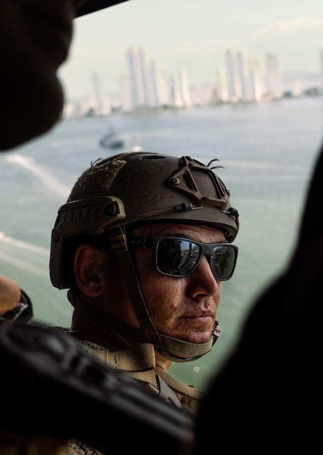 A U.S. reconnaissance Marine with 4th Reconnaissance Battalion, 4th Marine Division, sits on the edge of a U.S. Marine Corps UH-1Y Venom during helicopter rope suspension tactics training for UNITAS LXIV at Cartagena, Colombia, July 13, 2023. During UNITAS, reconnaissance and special operation force Marines from 11 partnered and allied nations conducted multilateral special operations training consisting of HRST, room clearing, visit board search and seizure, jungle patrolling, low level static line jumping, and small arms tactics. UNITAS, which is taking place in Colombia this year, is the world’s longest-running annual multinational maritime exercise that focuses on enhancing interoperability among multiple nations and joint forces during littoral and amphibious operations in order to build on existing regional partnerships and create new enduring relationships that promote peace, stability, and prosperity in the U.S. Southern Command’s area of responsibility. (U.S. Marine Corps photo by Sgt. Colton K. Garrett)