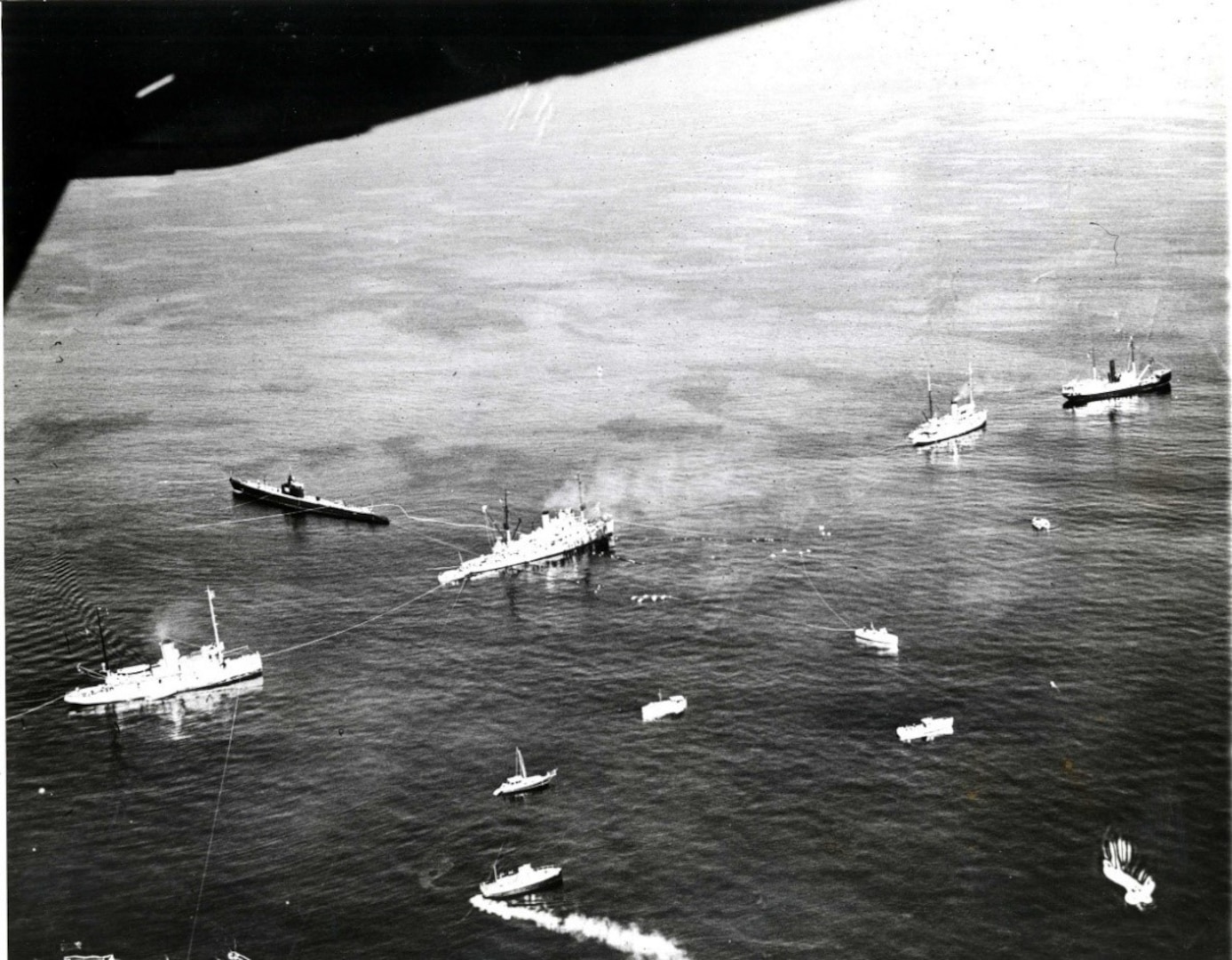 Aerial photograph showing, from left to right, fleet tug USS Wandank, submarine USS Sculpin, submarine rescue ship USS Falcon, naval shipyard tug Penacook, and Lighthouse Service tender Hibiscus, in addition to Coast Guard boats and spectator boats. (National Archives)