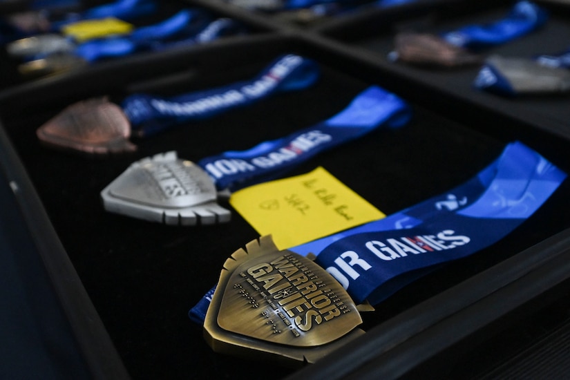 Medals sit on a table.