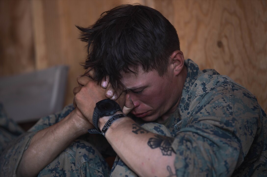 U.S. Marine Corps Lance Cpl. Robert Williamson, a gunner with 1st Battalion, 6th Marine Division, 2d Marine Division, partakes in a religious field service during Adversary Force Exercise (AFX) at Marine Corps Air Ground Combat Center, Twentynine Palms, California, April 26, 2022. The purpose of AFX is to create a credible, realistic threat for the exercise forces participating in the Integrated Training Exercise to engage against during the upcoming MAGTF Warfighting Exercise in a force-on-force, unscripted wargame. (U.S. Marine Corps photo by Lance Cpl. Megan Ozaki)