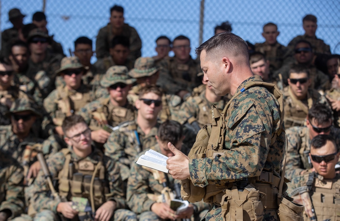 U.S. Navy Lt. Matthew Spurlock, a chaplain with 1st Battalion, 6th Marine Regiment, 2d Marine Division, conducts an Easter field service at a live-fire range during the Adversary Force Exercise (AFX) at Marine Corps Air Ground Combat Center, Twentynine Palms, California, April 17, 2022.  The purpose of AFX is to create a credible, realistic threat for the exercise forces participating in the Integrated Training Exercise to engage against during the upcoming MAGTF Warfighting Exercise in a force-on-force, unscripted wargame. (U.S. Marine Corps photo by Lance Cpl. Megan Ozaki)