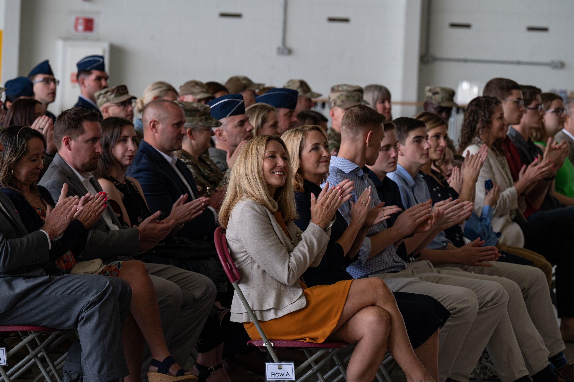 Family and friends of U.S. Air Force Col. Gene Jacobus and Chief Master Sgt. Michael Venning applaud during the 100th Air Refueling Wing change of command ceremony at Royal Air Force Mildenhall, England, July 17, 2023.