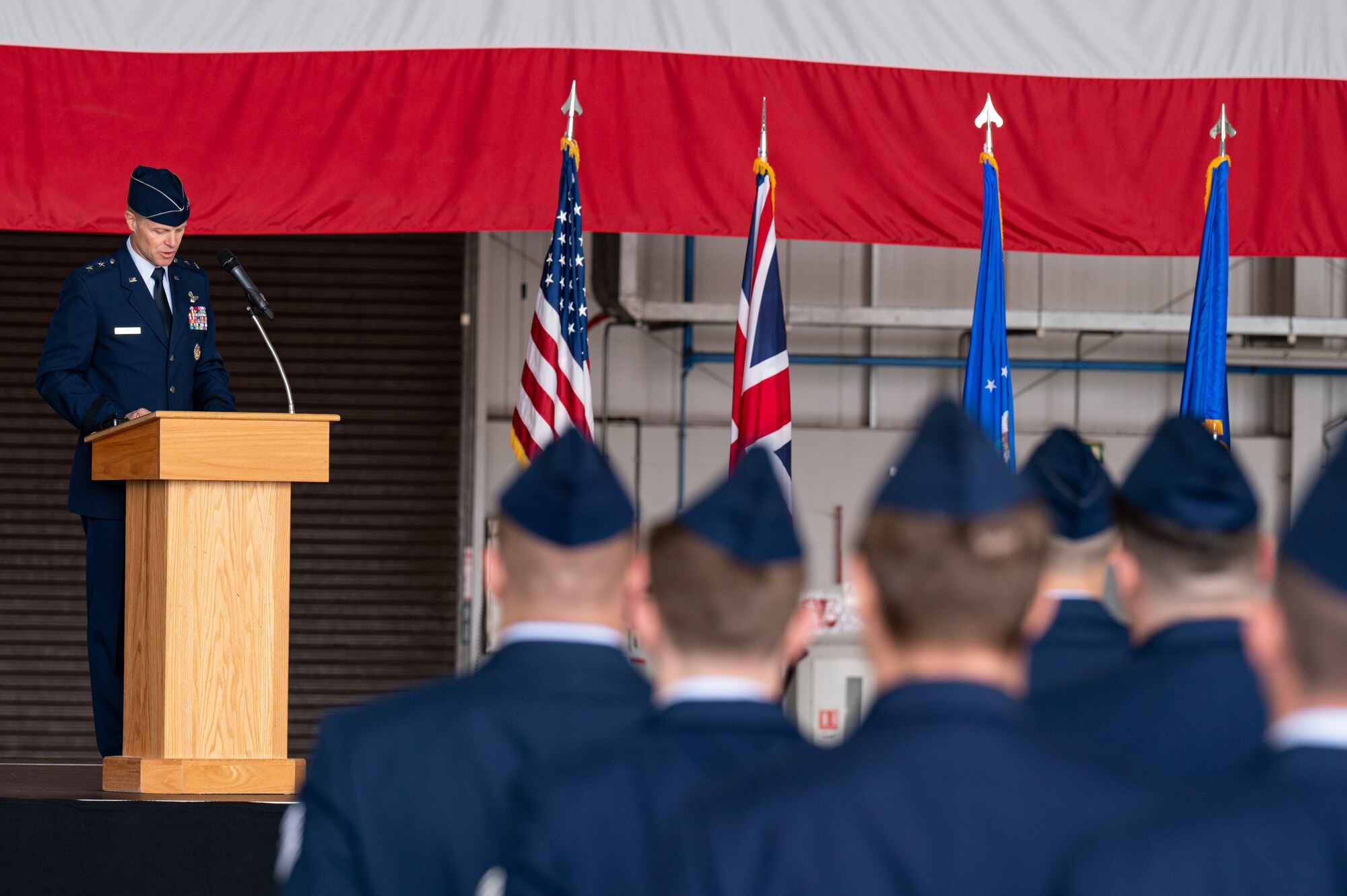 U.S. Air Force Maj. Gen. Derek France, 3rd Air Force commander, speaks to the audience about the achievements of Col. Gene Jacobus during the 100th Air Refueling Wing change of command ceremony at Royal Air Force Mildenhall, England, July 17, 2023.