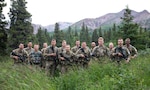 The 2023 Army National Guard Best Warrior Competition competitors pose for a group photo at Black Rapids Training Area, Alaska on July 10, 2023.