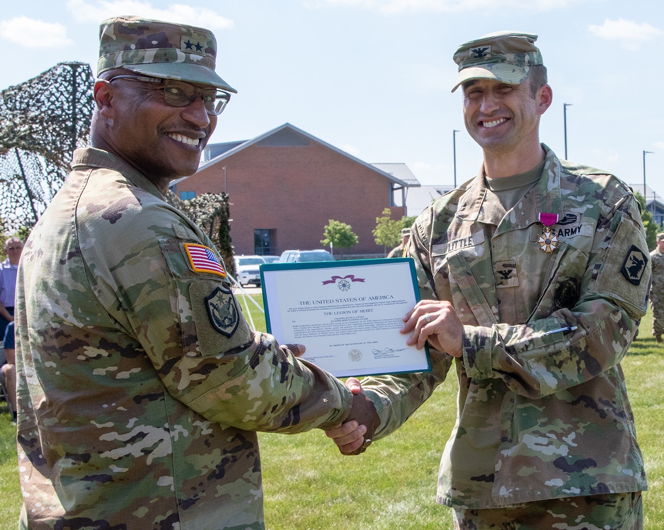 Col. Kevin Little, of Franklin, Illinois, outgoing Commander of the 404th Maneuver Enhancement Brigade, is presented with the Legion of Merit by Maj. Gen. Rodney Boyd, of Naperville, Illinois, Assistant Adjutant General – Army and Commander of the Illinois Army National Guard, during the change of command ceremony July 14 at the brigade’s headquarters on the campus of Heartland Community College in Normal, Illinois