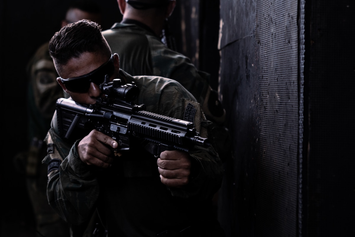 A Brazilian Marine provides rear security during visit board search and seizure training during UNITAS LXIV at Cartagena, Colombia, July 12, 2023.
