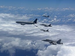 U.S. Marine Corps F/A-18 Hornets assigned to Marine Fighter Attack Squadron 323, Marine Aircraft Group 11, 3rd Marine Aircraft Wing, conduct air-to-air refueling with a U.S. Air Force KC-135 Stratotanker during a trans-Pacific flight en route to Marine Aviation Support Activity 23, at sea, July 8, 2023. MASA is a bilateral exercise between the Armed Forces of Philippines and the U.S. Marine Corps, aimed at enhancing interoperability and coordination focused on aviation-related capabilities.