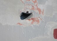 The finished product of the scupper is attached beneath the overboard discharge port on the hull of USS Kidd (DDG 100) in Everett, Wash., on June 21. (U.S. Navy photo provided by Dr. Maureen Foley)