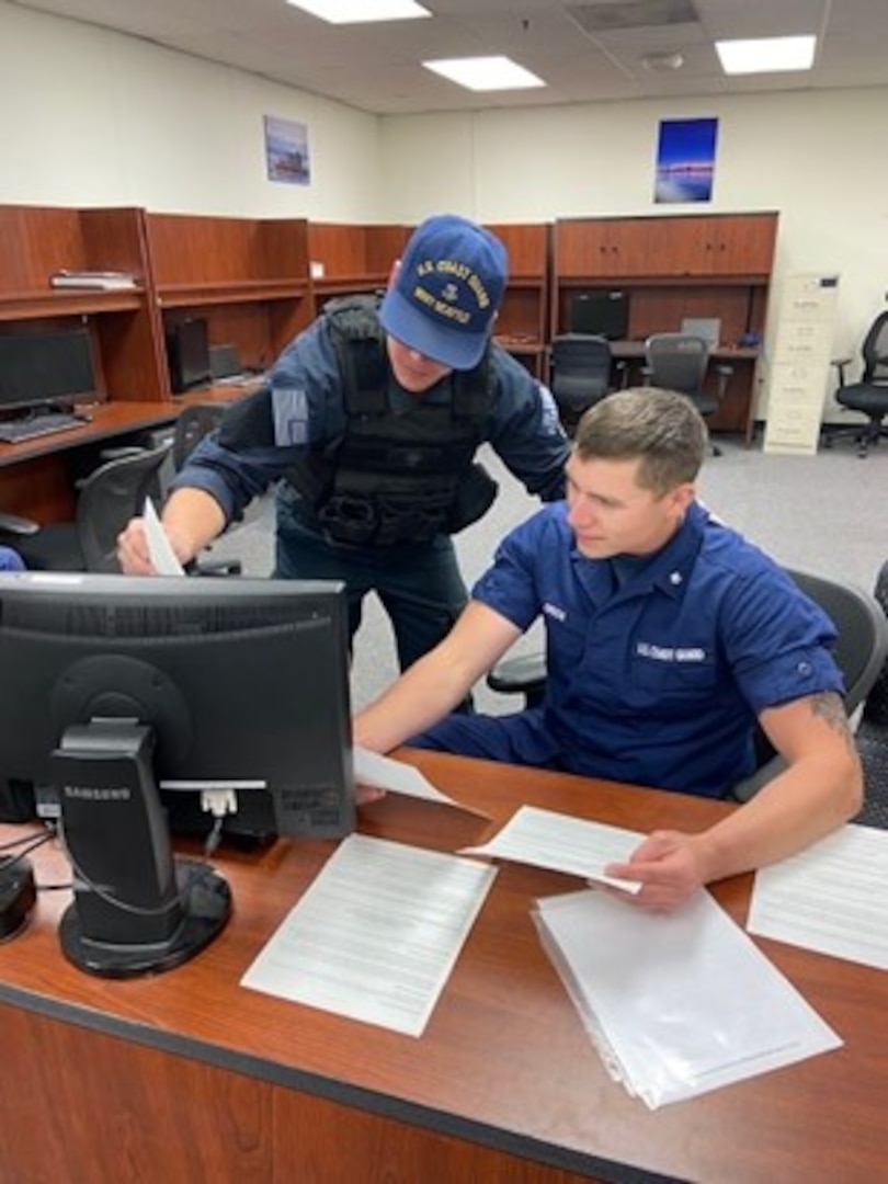 Coast Guard Maritime Safety and Security Team (MSST) Seattle 91101 members Petty Officer 2nd Class Trevor Miller and Petty Officer 3rd Class Wyatt Green discuss Alaska fisheries regulations. In this picture, they are reviewing a 4100-F or Report of Boarding-Fisheries Form. These will be used during every boarding MSST Seattle conducts during their Kodiak operations. In it, they note the vessel’s name, all inspected items, any violations found, and MSST Seattle unit information. All fishermen will receive a copy of their 4100-F at the conclusion of the boarding. Coast Guard courtesy photo.