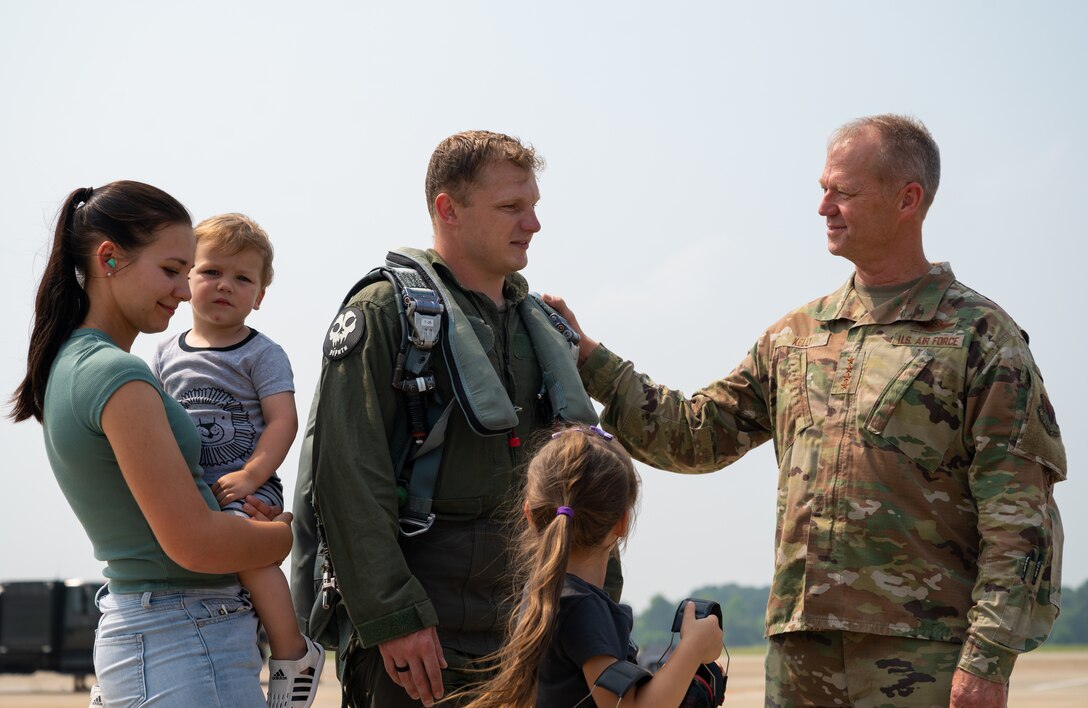 Senior Airman Kostiantyn Khymchenko is surpirsed on the flightline by his family, friends, coworkers, the COMACC and the command chief of ACC