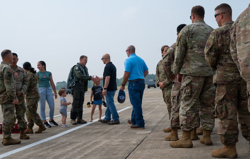 Senior Airman Kostiantyn Khymchenko is surpirsed on the flightline by his family, friends, coworkers, the COMACC and the command chief of ACC