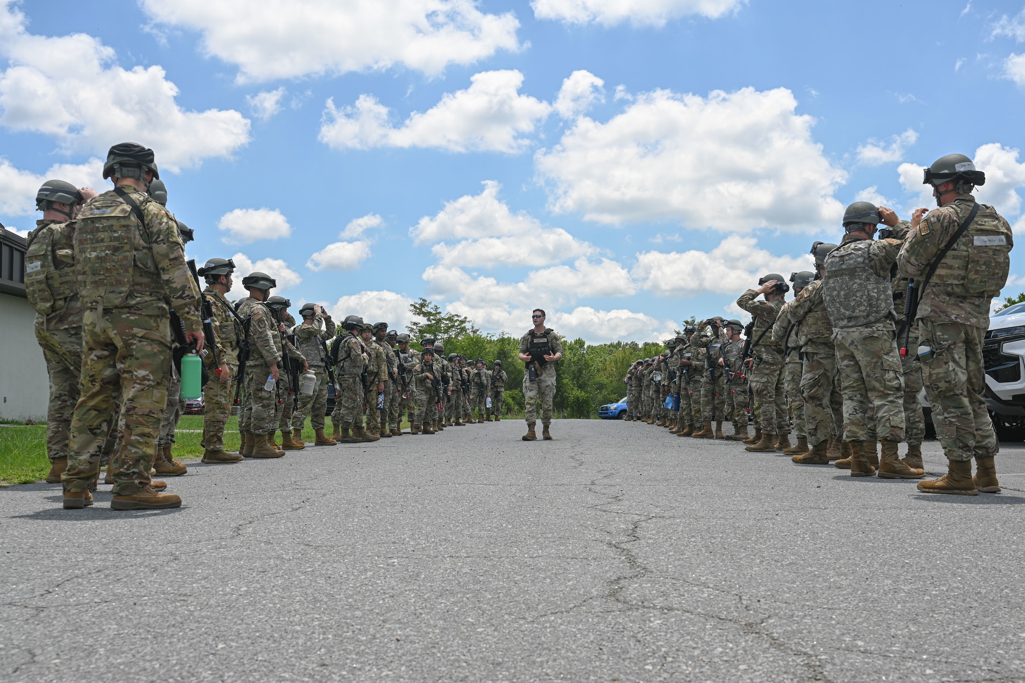 Airmen are being briefed by a man in uniform